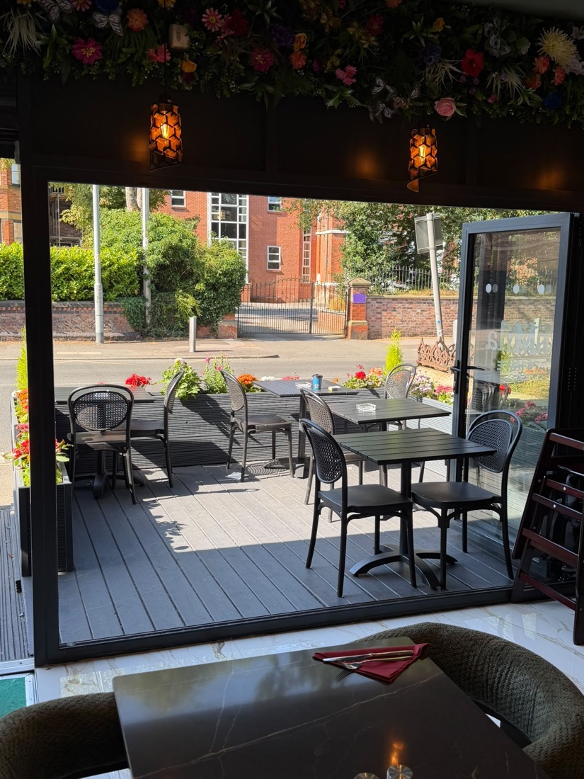 Outdoor terrace seating with flower canopy